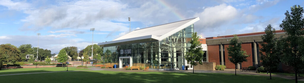 the outside of slavin center with a rainbow in the sky
